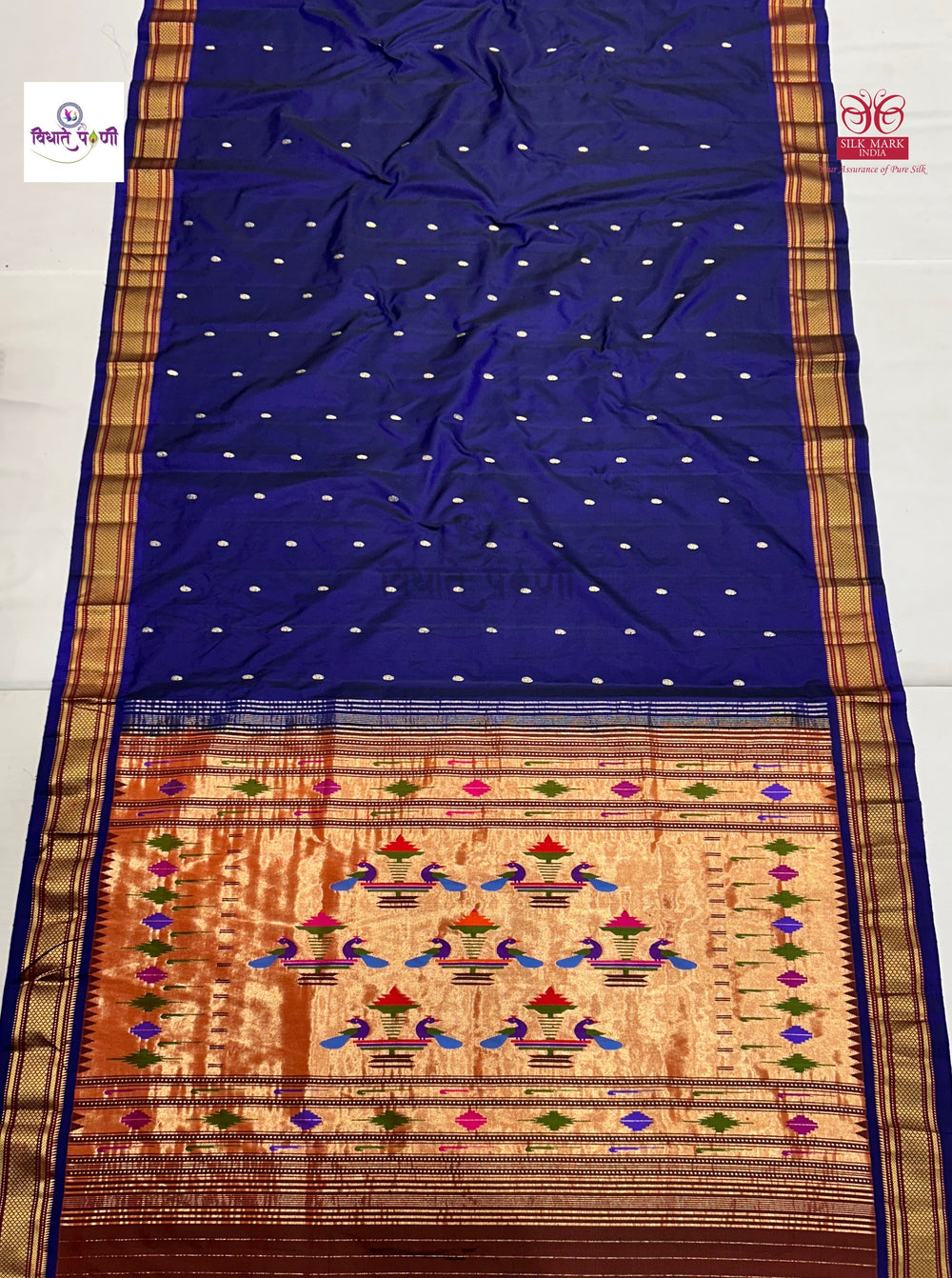 Blue saree with a colorful border and pattern on a white background
