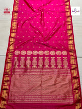 A bright pink paithani silk saree with gold zari embroidery, featuring a wide border with traditional motifs and a patterned body with small gold dots.